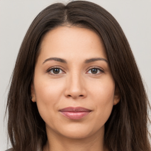 Joyful white young-adult female with long  brown hair and brown eyes