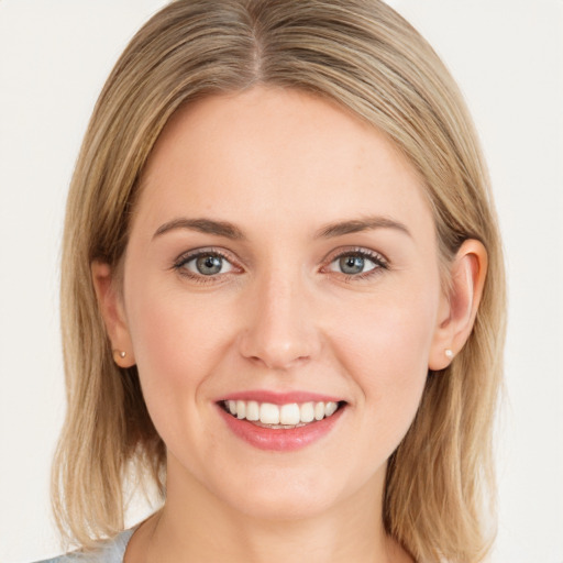 Joyful white young-adult female with medium  brown hair and green eyes