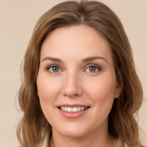 Joyful white young-adult female with medium  brown hair and green eyes