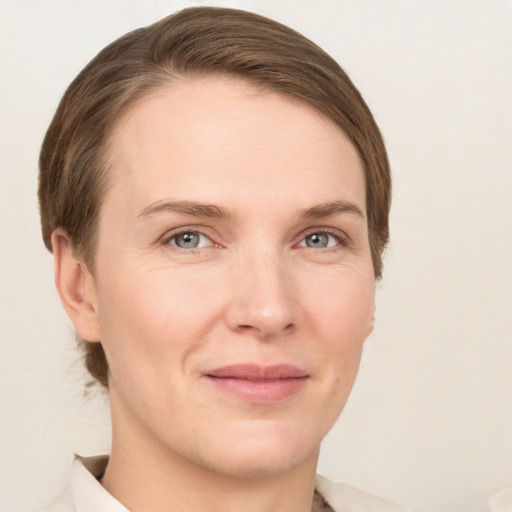 Joyful white young-adult female with short  brown hair and grey eyes