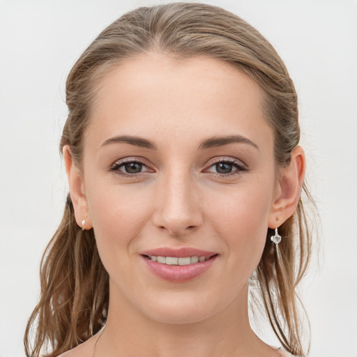 Joyful white young-adult female with long  brown hair and blue eyes