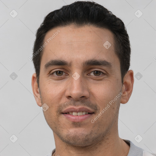 Joyful white young-adult male with short  black hair and brown eyes