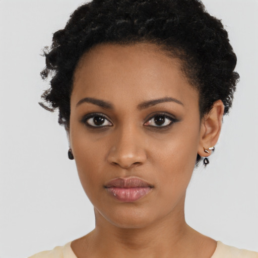 Joyful black young-adult female with short  black hair and brown eyes