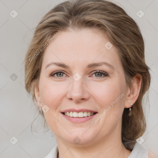 Joyful white adult female with medium  brown hair and blue eyes