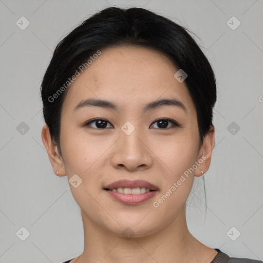 Joyful asian young-adult female with short  black hair and brown eyes