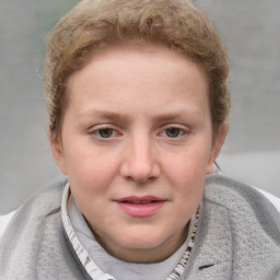 Joyful white young-adult female with short  brown hair and blue eyes