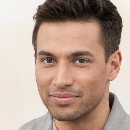 Joyful white young-adult male with short  brown hair and brown eyes