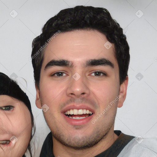 Joyful white young-adult male with short  black hair and brown eyes