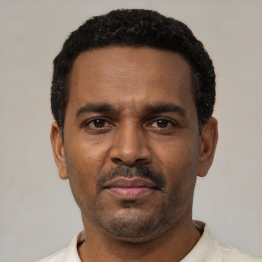 Neutral black adult male with short  black hair and brown eyes