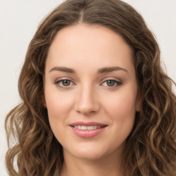 Joyful white young-adult female with long  brown hair and green eyes