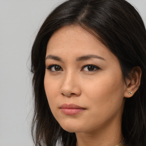 Joyful asian young-adult female with long  brown hair and brown eyes