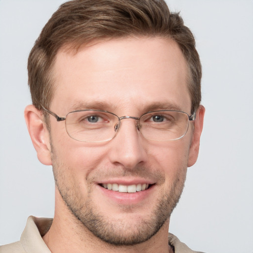 Joyful white adult male with short  brown hair and grey eyes