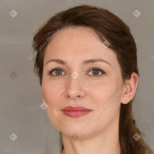 Joyful white adult female with medium  brown hair and green eyes