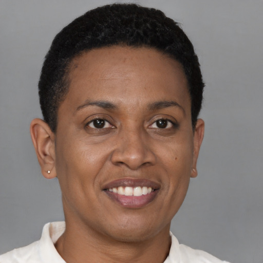 Joyful black young-adult female with short  brown hair and brown eyes