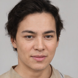 Joyful latino young-adult male with short  brown hair and brown eyes