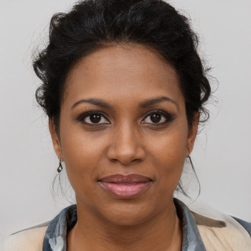 Joyful black young-adult female with medium  brown hair and brown eyes