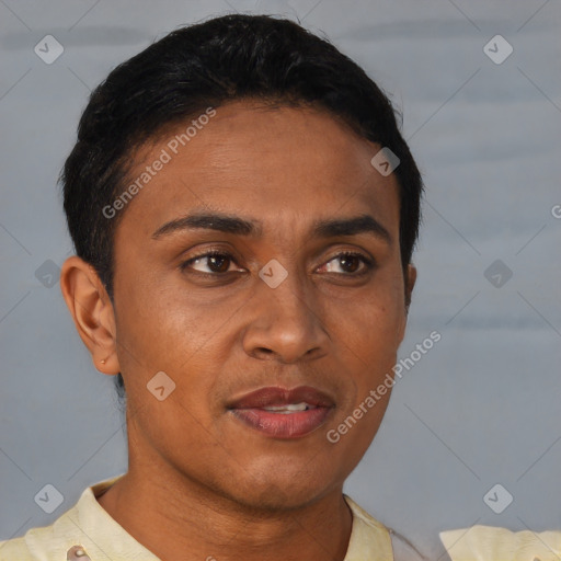 Joyful latino young-adult male with short  brown hair and brown eyes