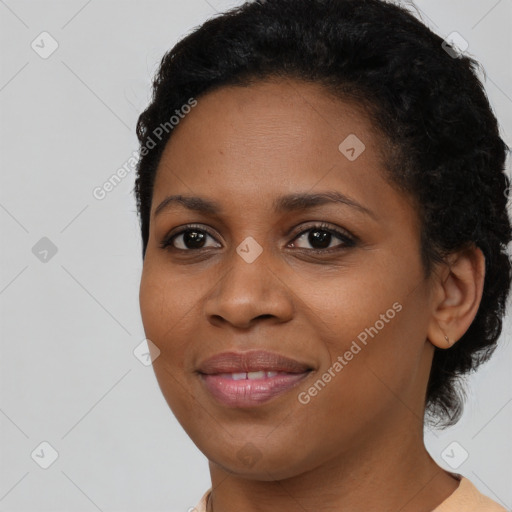 Joyful black young-adult female with short  brown hair and brown eyes