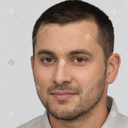 Joyful white young-adult male with short  brown hair and brown eyes