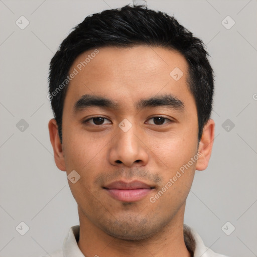 Joyful asian young-adult male with short  black hair and brown eyes