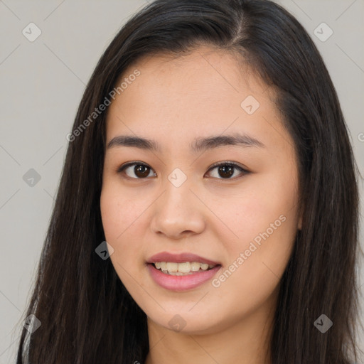 Joyful asian young-adult female with long  brown hair and brown eyes