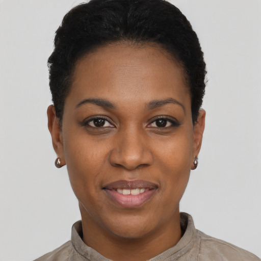 Joyful black young-adult female with short  black hair and brown eyes