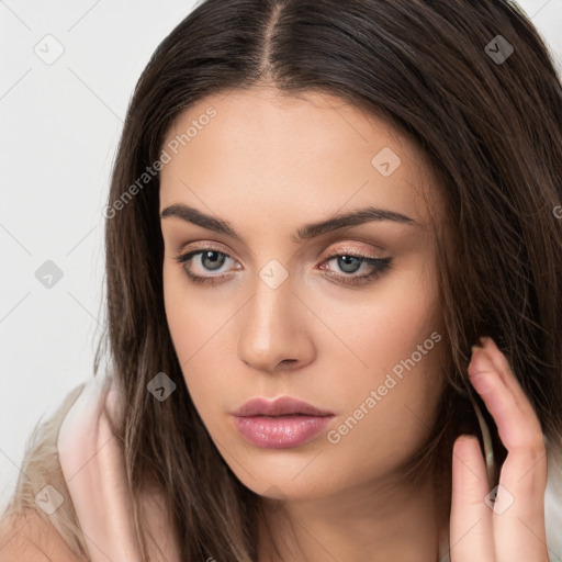 Neutral white young-adult female with long  brown hair and brown eyes