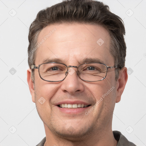 Joyful white adult male with short  brown hair and grey eyes