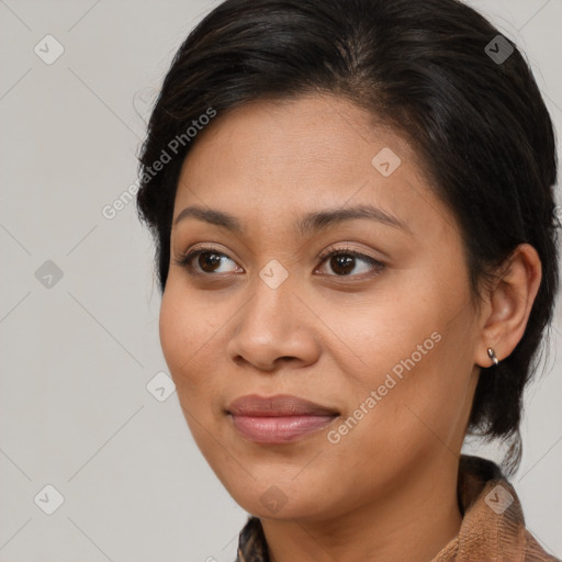 Joyful latino young-adult female with medium  brown hair and brown eyes