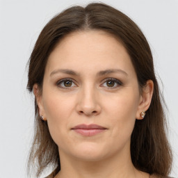 Joyful white young-adult female with long  brown hair and grey eyes