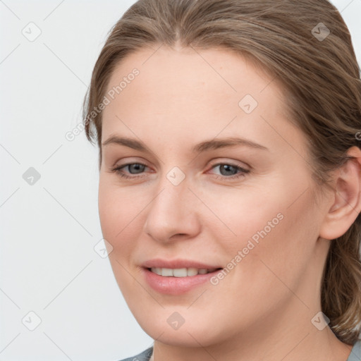 Joyful white young-adult female with long  brown hair and grey eyes