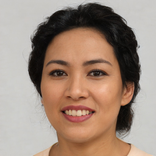 Joyful latino young-adult female with medium  brown hair and brown eyes