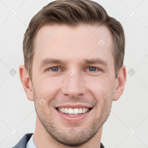 Joyful white young-adult male with short  brown hair and grey eyes