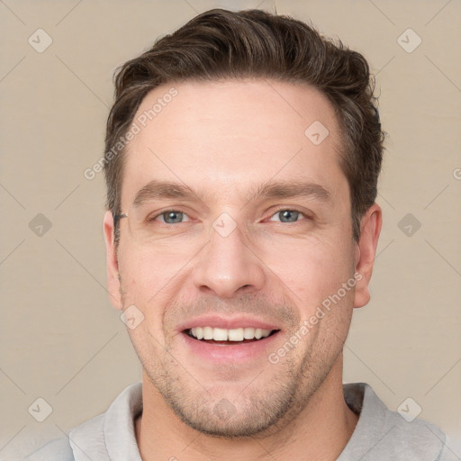 Joyful white adult male with short  brown hair and grey eyes