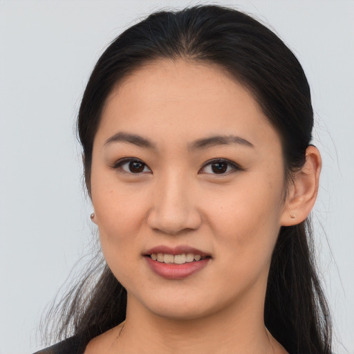 Joyful asian young-adult female with long  brown hair and brown eyes