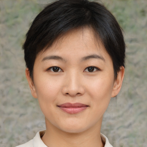 Joyful asian young-adult female with short  brown hair and brown eyes