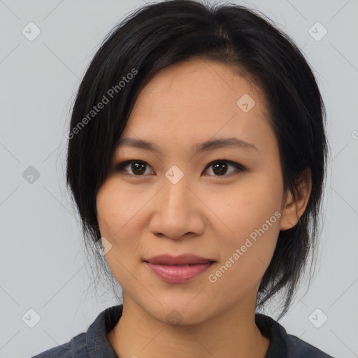 Joyful asian young-adult female with medium  black hair and brown eyes