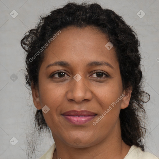 Joyful black adult female with medium  brown hair and brown eyes