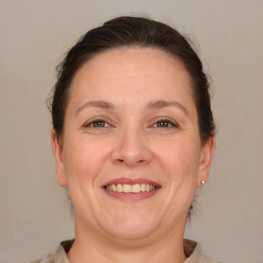 Joyful white adult female with medium  brown hair and brown eyes