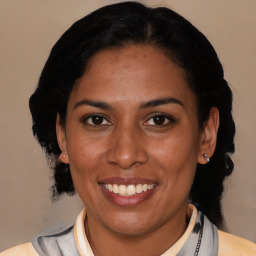 Joyful latino young-adult female with medium  black hair and brown eyes