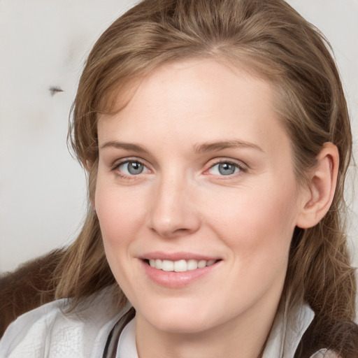 Joyful white young-adult female with medium  brown hair and blue eyes