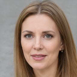 Joyful white adult female with long  brown hair and grey eyes