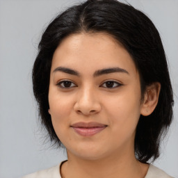 Joyful latino young-adult female with medium  black hair and brown eyes