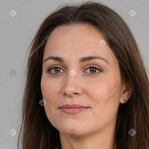 Joyful white adult female with long  brown hair and brown eyes