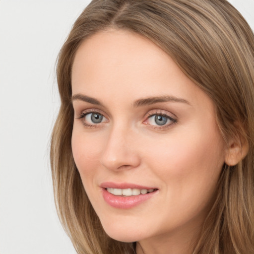 Joyful white young-adult female with long  brown hair and blue eyes