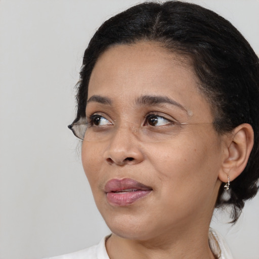 Joyful white adult female with medium  black hair and brown eyes