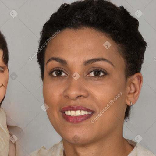 Joyful black young-adult female with short  brown hair and brown eyes