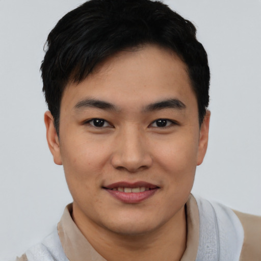 Joyful asian young-adult male with short  black hair and brown eyes
