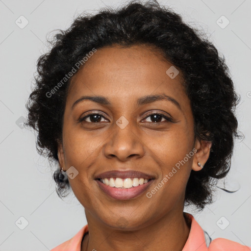 Joyful black young-adult female with long  brown hair and brown eyes