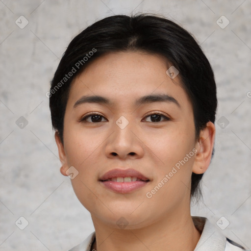 Joyful asian young-adult female with short  black hair and brown eyes